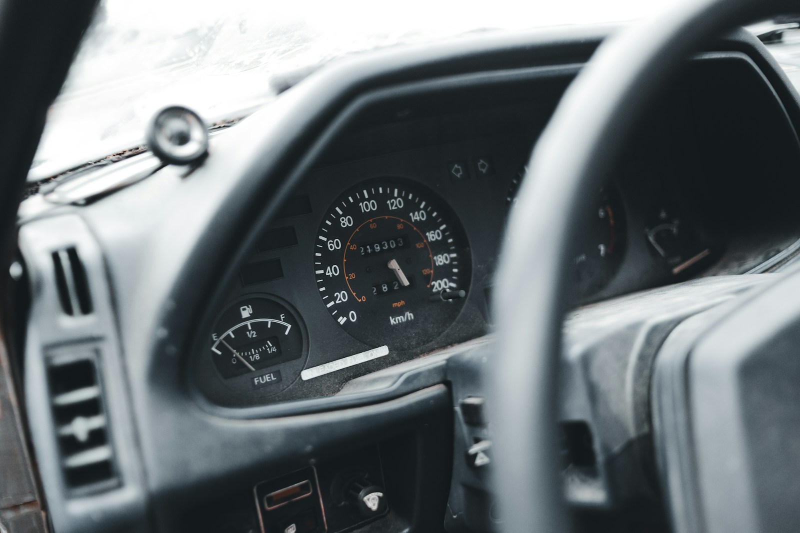 a dashboard of a car with a speedometer and a dash light
