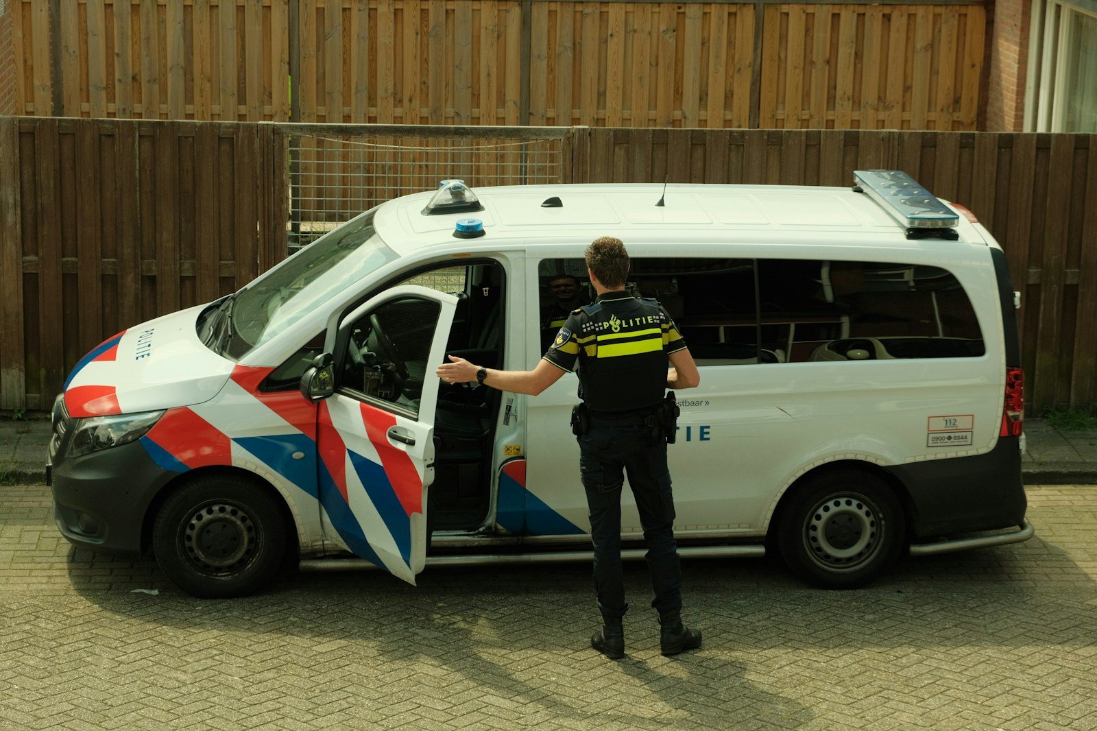 a police officer standing next to a van