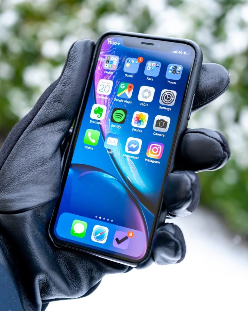 a person holding a cell phone in their hand