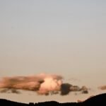 A large cloud of smoke is in the sky